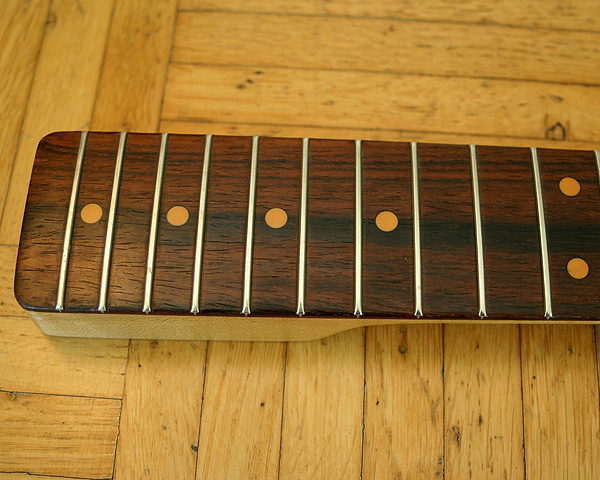 I wonder if the fingerboard of the Schecter neck is Brazilian rosewood or Cocobolo. This info must be in the neck code which says F773S but this code is not included in the (older) Schecter catalogue I have.