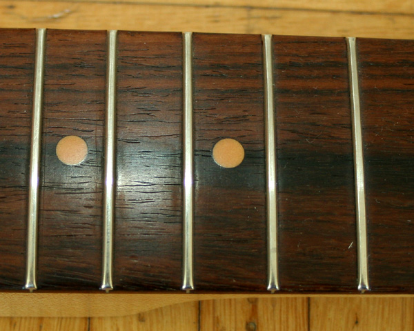 Those grains indicate a South American rosewood, and the wood has a typical oily shine. Cocobola is often lighter than Braz rosewood but the latter can vary to a large extend.