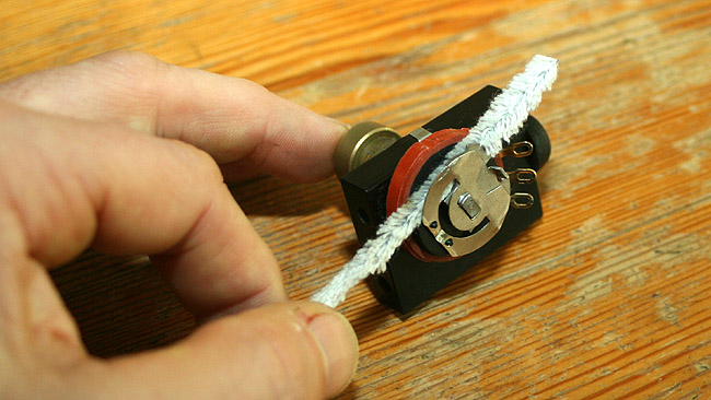 Next use a pipe cleaner soaked with pure alcohol to clean the carbon resistor.